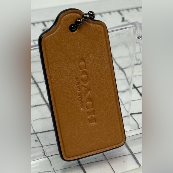 Coach Tan and snake embossed. Two tone. Leather hang tag.  3.5 by 1.25 inches. - Picture 2 of 3